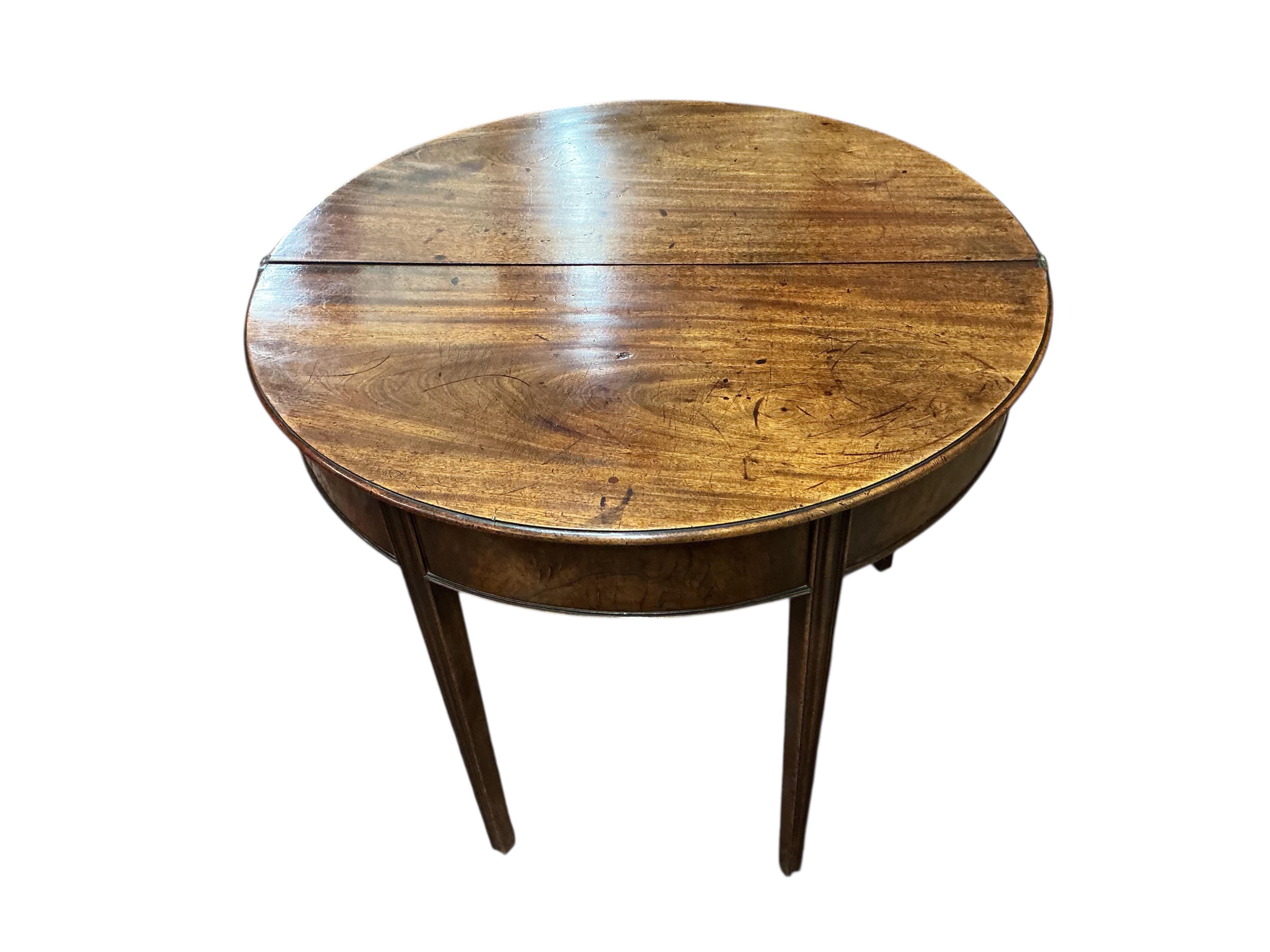 A George III mahogany demi lune folding tea table, width 93cm, depth 46cm, height 74cm